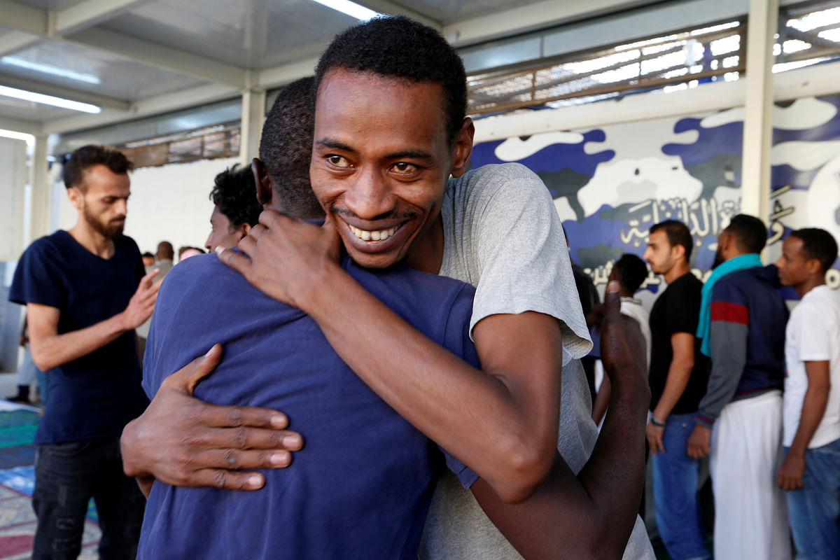 Muslim migrants exchange greetings after Eid al-Fitr prayers to mark the end of the holy fasting month of Ramadan at a detention centre in Tripoli, Libya. Photo: Reuters