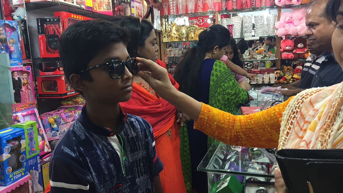 Trying on sunglasses at Twin Tower Concord Shopping complex on Thursday. Photo: Farjana Liakat