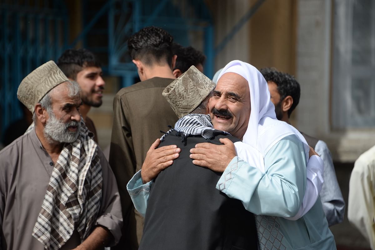 Afghan Muslims hug each other after offering prayers at the start of the Eid al-Fitr holiday which marks the end of Ramadan at the Shah-e Do Shamshira mosque in Kabul. Afghans welcomed the start of the Taliban`s first ceasefire since the 2001 US invasion on 15 June, as they celebrated Eid al-Fitr. Photo: AFP