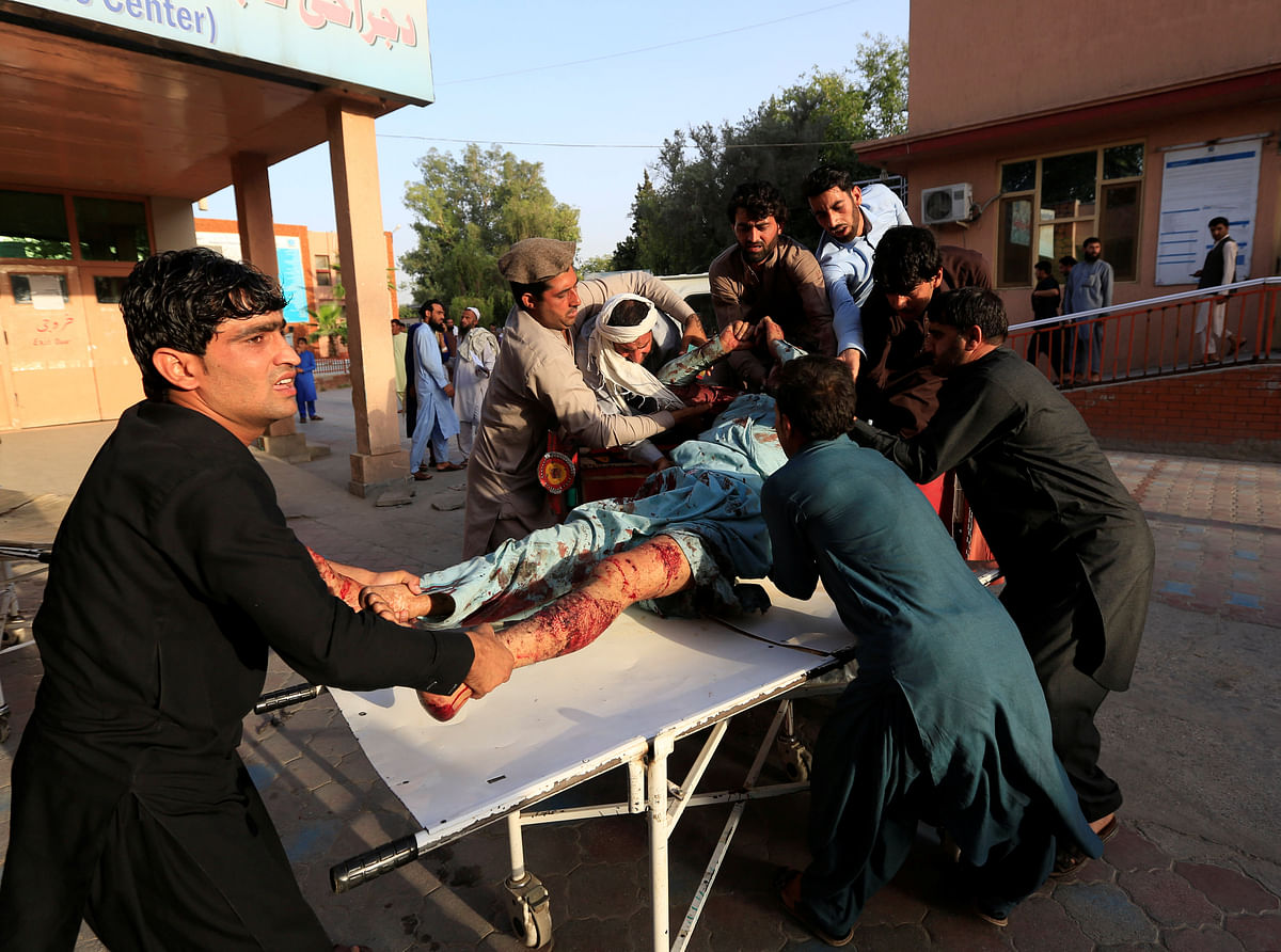 Men carry an injured man in a hospital after a car bomb, Jalalabad city, Afghanistan on 16 June 2018. Photo: Reuters