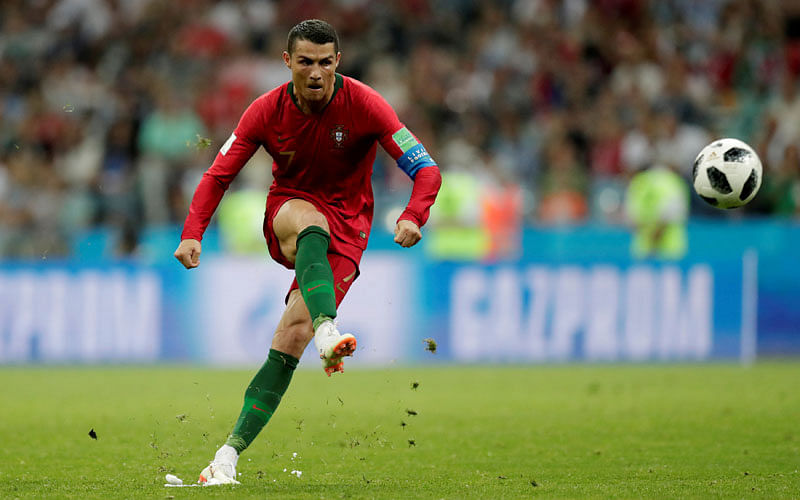 Portugal`s Cristiano Ronaldo scores their third goal from a free kick to complete his hat-trick on 15 June 2018. Photo: Reuters