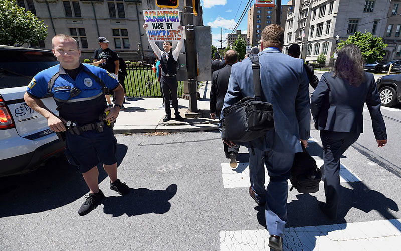Jonathan Wilson, 33, of Scranton, Pa., holds a sign outside of a Lackawanna College were US attorney Jeff Sessions spoke on immigration policy and law enforcement actions on 15 June. Photo: AP