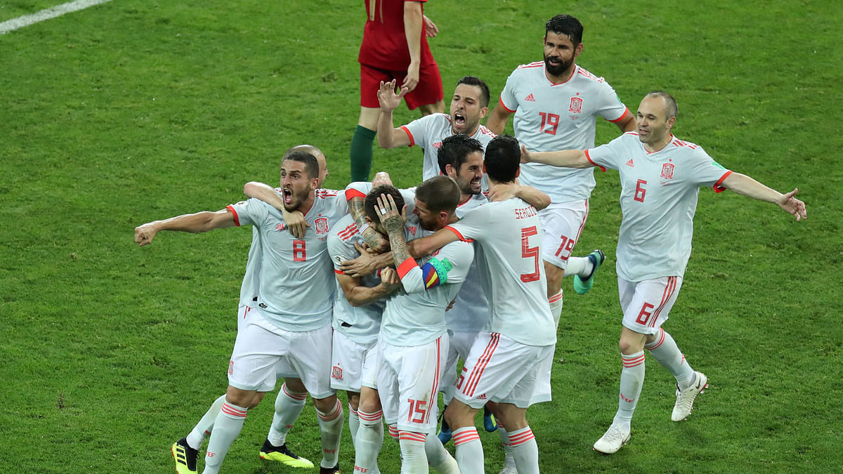 Spain`s Nacho celebrates scoring their third goal with team mates REUTERS