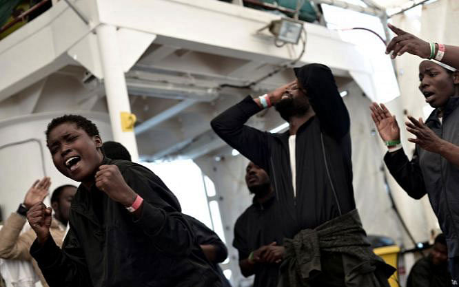 Migrants sing on the deck of MV Aquarius, a search and rescue ship run in partnership between SOS Mediterranee and Medecins Sans Frontieres on the way to Spain on 16 June 2018. Photo: Reuters