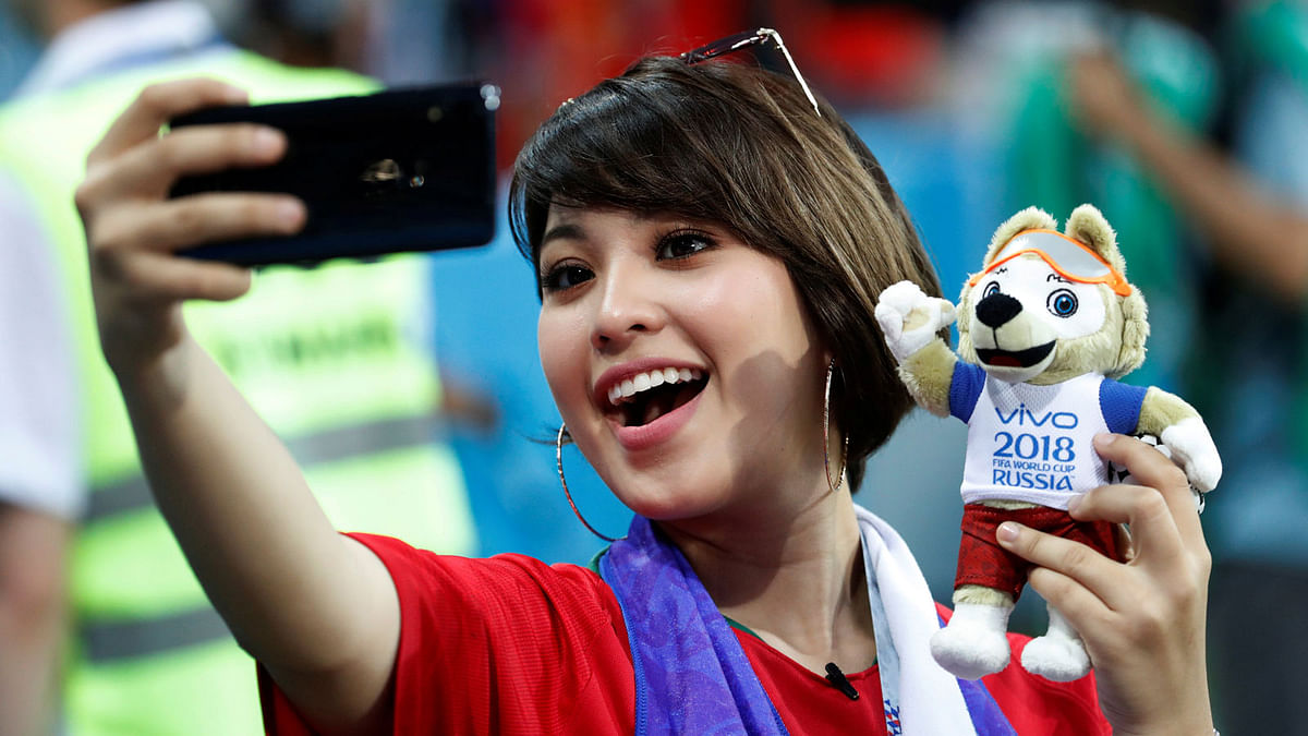 Fan takes a selfie with a toy of mascot Zabivaka before the match on 15 June 2018. Photo: Reuters