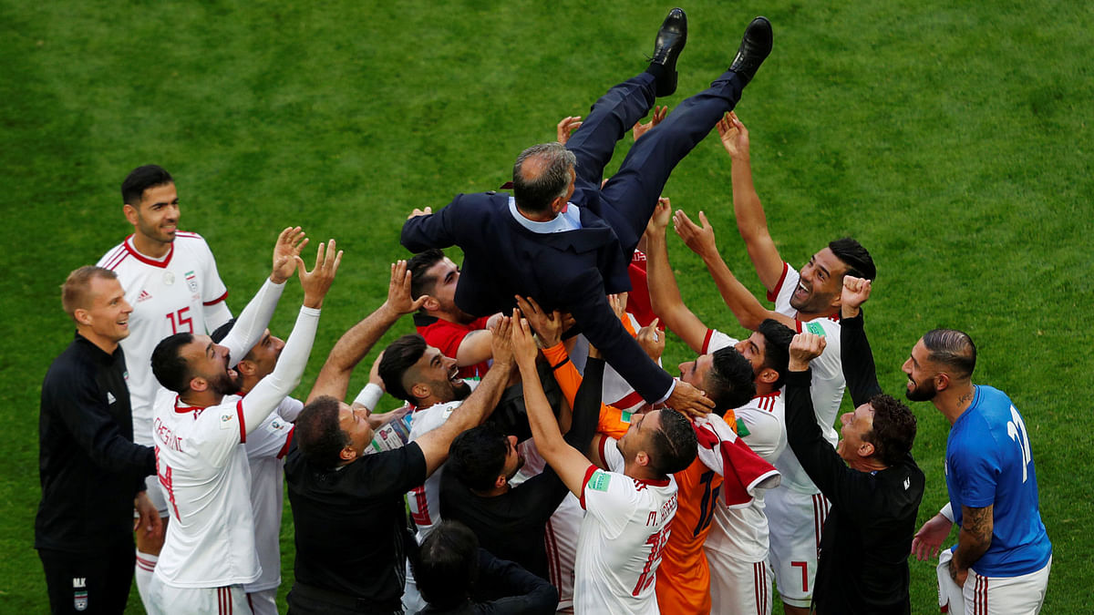 Iran coach Carlos Queiroz celebrates after the match with players on 15 June 2018. Photo: Reuters