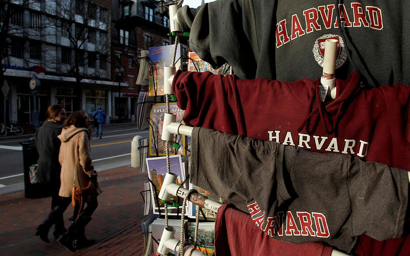 People walk past Harvard University t-shirts for sale in Harvard Square in Cambridge, Massachusetts, US 16 November, 2012. Photo: Reuters