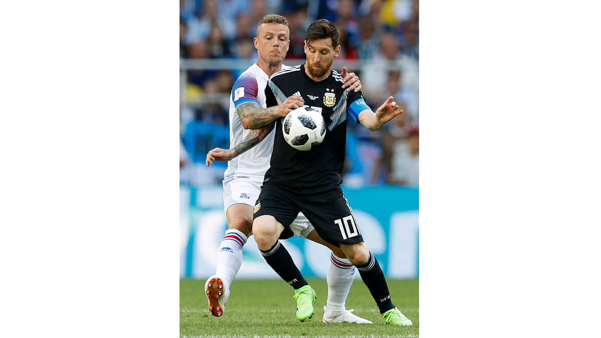 Iceland`s Ragnar Sigurdsson, left, and Argentina`s Lionel Messi fight for the ball during the group D match between Argentina and Iceland at the 2018 soccer World Cup in the Spartak Stadium in Moscow, Russia on 16 June. Photo: AP