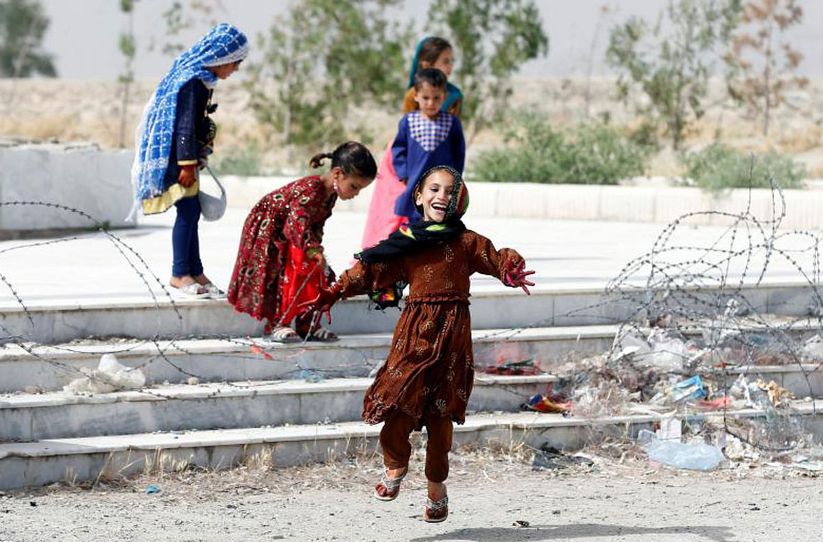 Afghan girls play on the first day of the Muslim holiday of Eid al-Fitr in Kabul, Afghanistan on 15 June 2018. Photo: Reuters