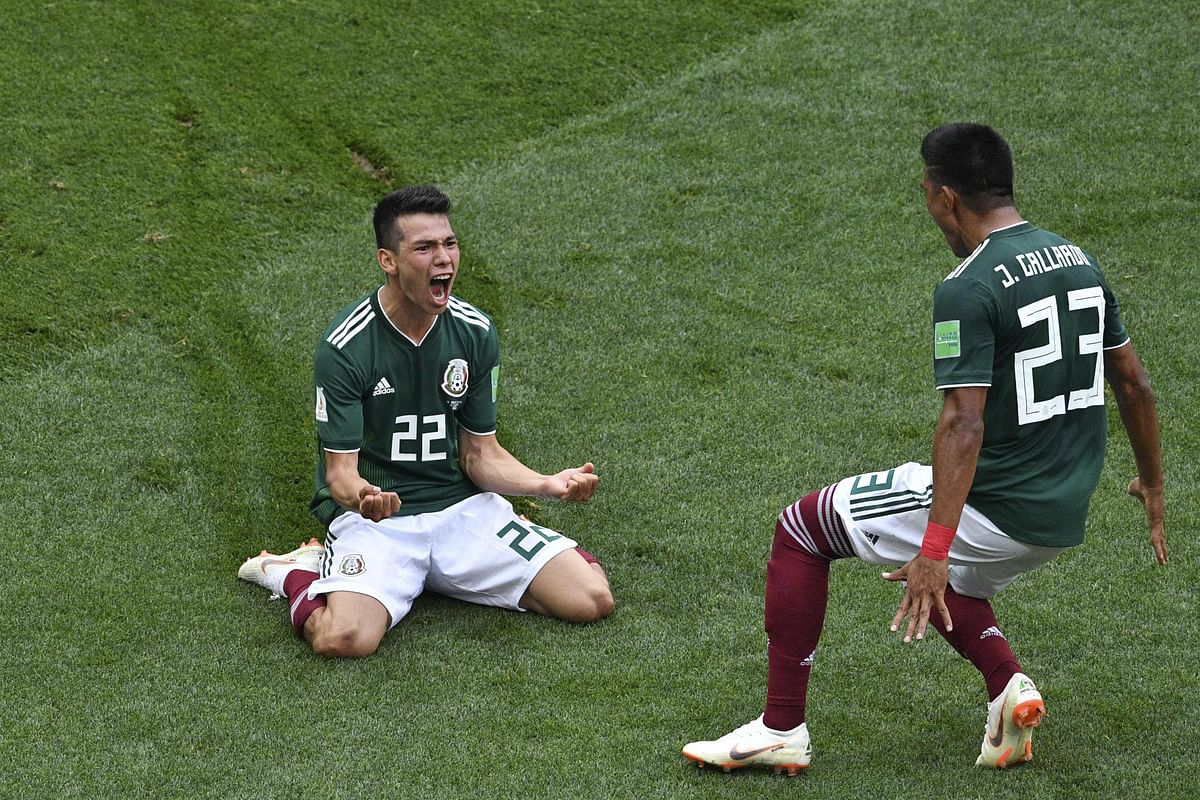Mexico forward Hirving Lozano (L) celebrates after scoring the winner against Germany during their Group F match at the Luzhniki Stadium in Moscow on June 17, 2018. AFP