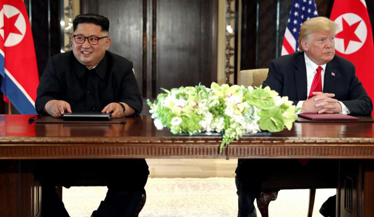 US president Donald Trump and North Korea’s leader Kim Jong Un hold a signing ceremony at the conclusion of their summit at the Capella Hotel on the resort island of Sentosa, Singapore 12 June.