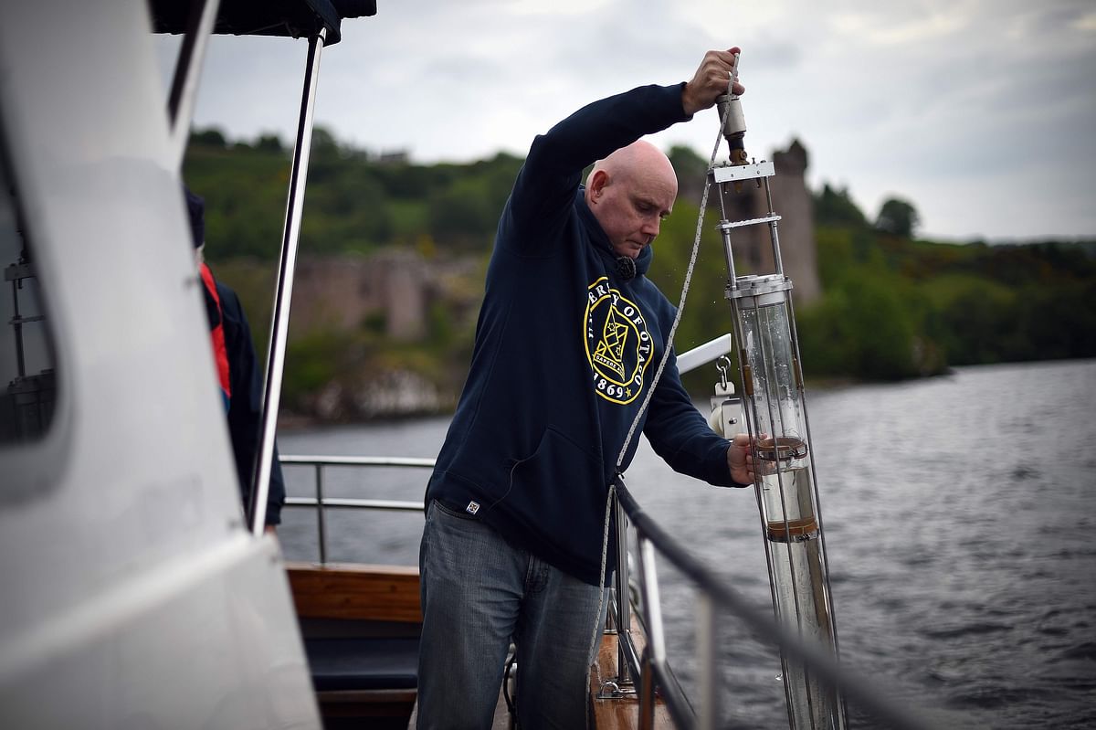Professor Neil Gemmell takes samples on his boat as he conducts research into the DNA present in the waters of Loch Ness in the Scottish Highlands, Scotland on 11 June 2018. Photo: AFP