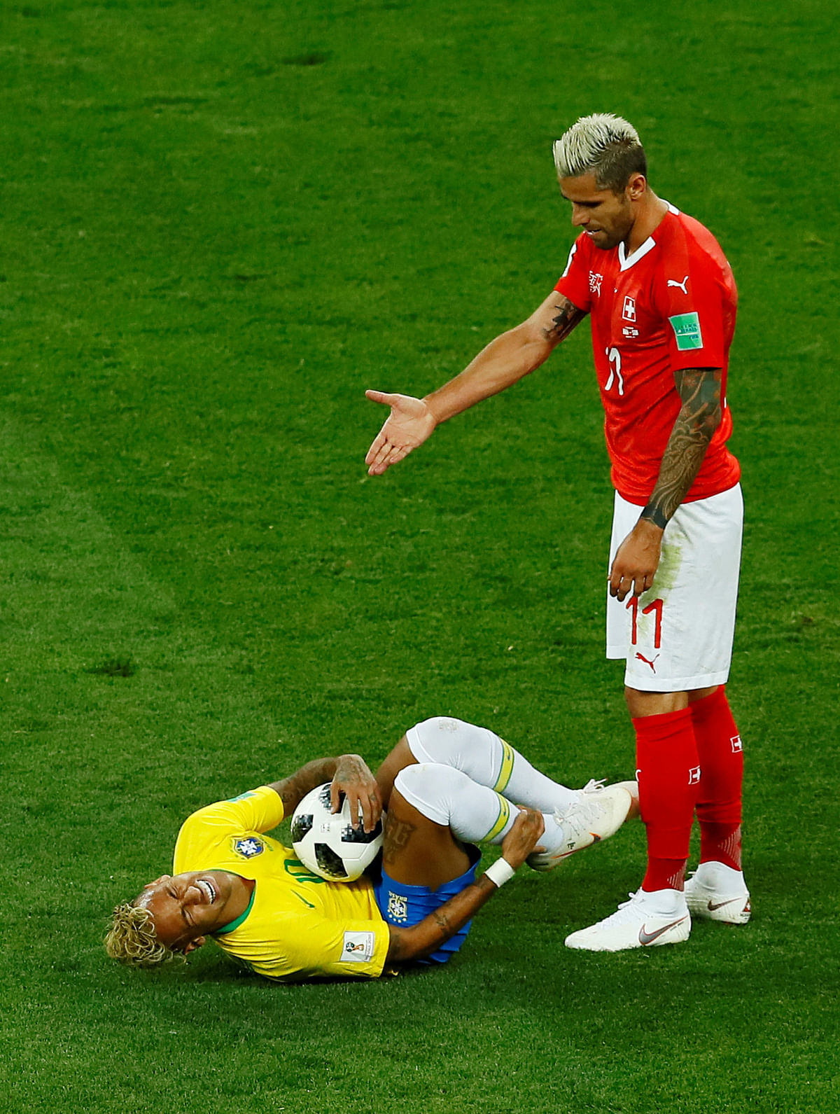 Switzerland`s Valon Behrami gestures next to Brazil`s Neymar at FIFA World Cup match between Brazil vs Switzerland on 17 June. Photo: Reuters