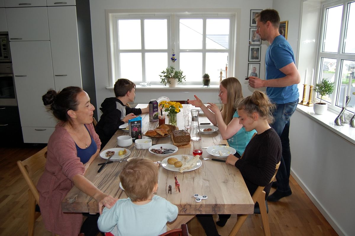 Gunnhild Helmsdal (L) and her husband Eli Joensen (R) have diner with their children at their home on 5 June 2018 in Hoyvik, on the Streymoy Island, the largest of Faroe Islands in this Atlantic ocean archipelago nation. Photo: AFP