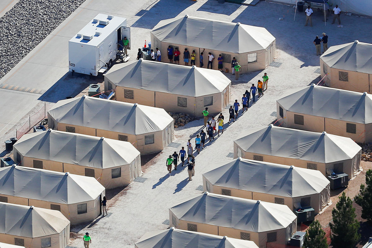 Immigrant children now housed in a tent encampment under the new `zero tolerance` policy by the Trump administration are shown walking in single file at the facility near the Mexican border in Tornillo, Texas, US on 19 June 2018. Photo: Reuters