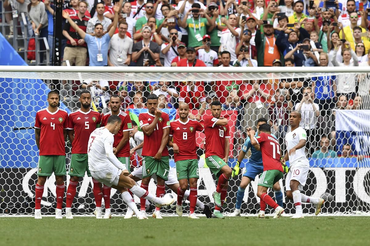 Portugal`s forward Cristiano Ronaldo (C) shoots a free kick during the Russia 2018 World Cup Group B football match between Portugal and Morocco at the Luzhniki Stadium in Moscow on 20 June 2018. Photo: AFP