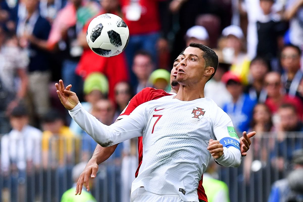 Portugal`s forward Cristiano Ronaldo (front C) controls the ball next to Morocco`s midfielder Faycal Fajr (rear C) during the Russia 2018 World Cup Group B football match between Portugal and Morocco at the Luzhniki Stadium in Moscow on 20 June 2018. Photo: AFP