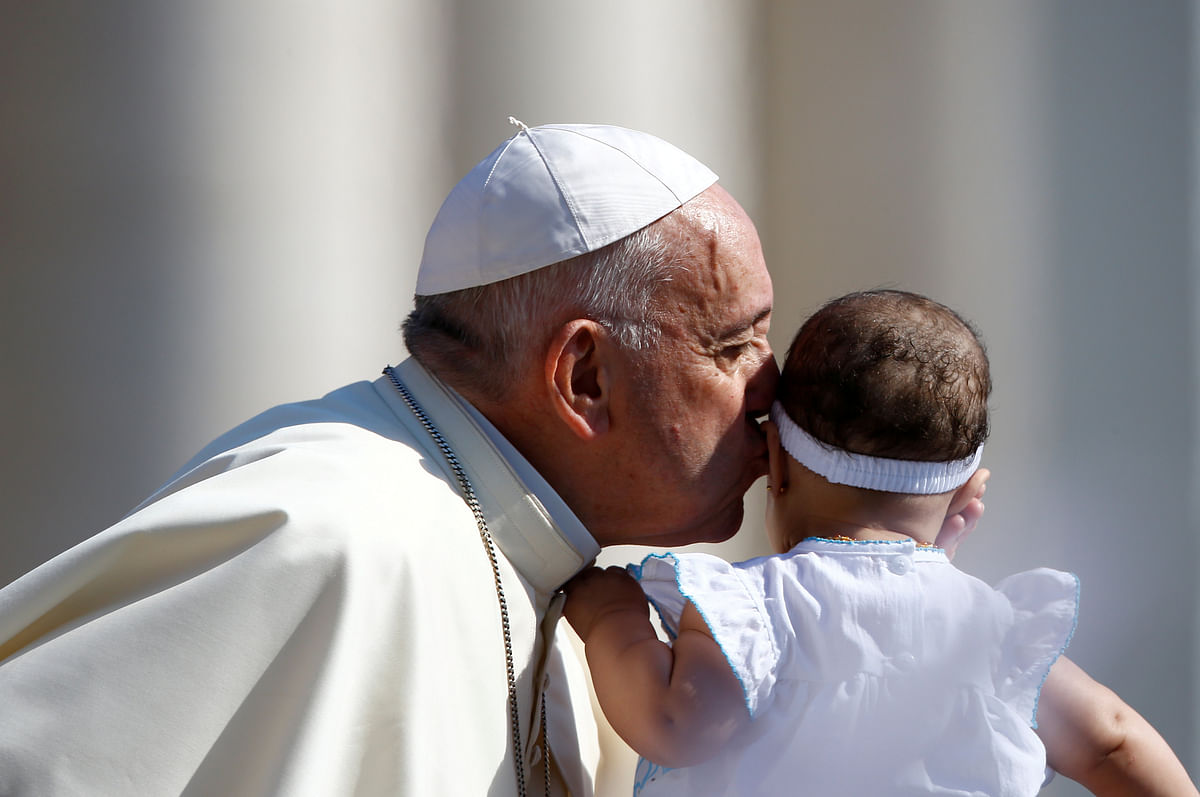 Pope Francis kisses a baby during the Wednesday general audience in Saint Peter`s square at the Vatican, 20 June 2018. Photo: Reuters