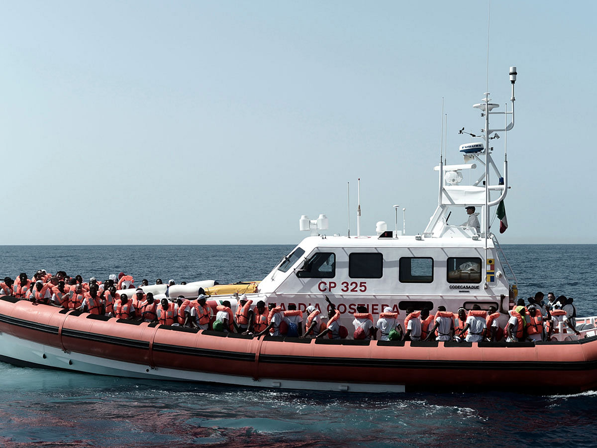 This 12 June 2018 photo released Wednesday, 13 June 2018 by French NGO `SOS Mediterranee` shows migrants being transferred from the Aquarius ship to Italian Coast Guard boats, in the Mediterranean Sea. Italy dispatched two ships Tuesday to help take 629 migrants stuck off its shores on the days-long voyage to Spain, after the new populist government refused them safe port in a dramatic bid to force Europe to share the burden of unrelenting arrivals. Photo: AP