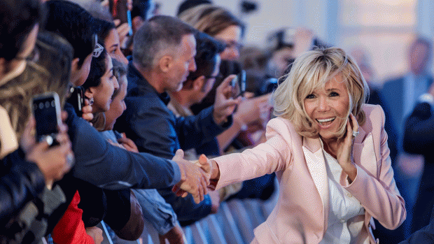 Brigitte Macron, the wife of the French president, greets people during the Fete de la Musique the music day celebration in the courtyard of the Elysee Palace, in Paris. Photo: Reuters
