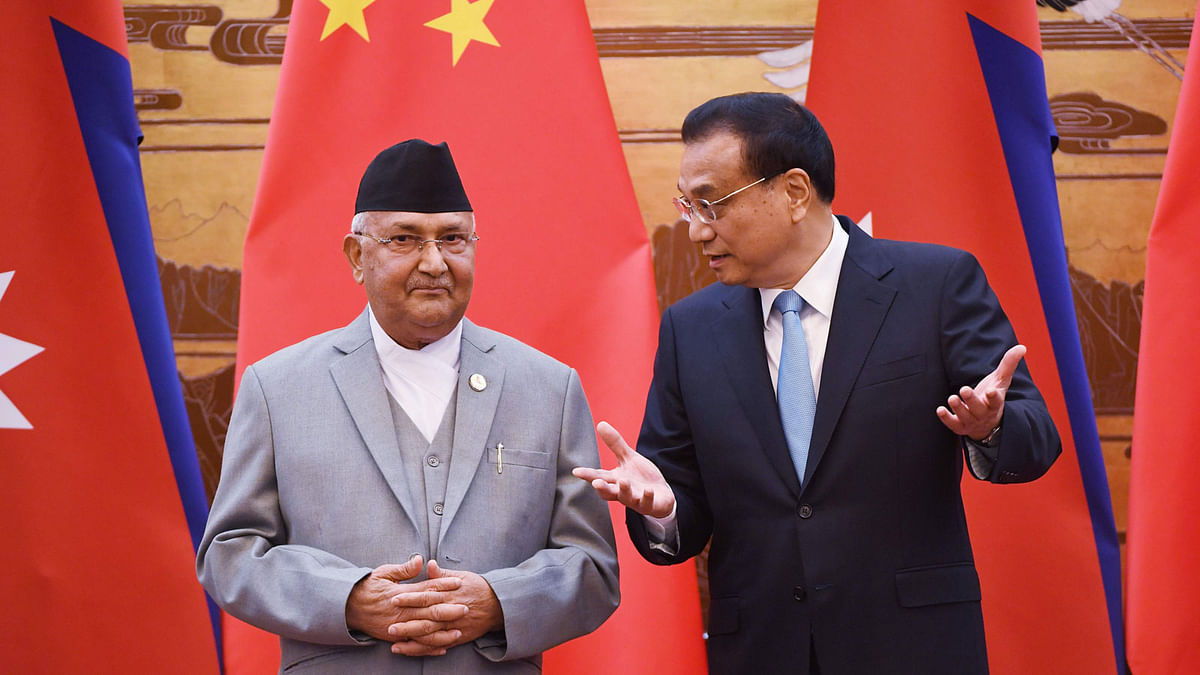 Nepal`s prime minister KP Sharma Oli (L) chats with Chinese premier Li Keqiang during a signing ceremony at the Great Hall of the People in Beijing on 21 June 2018. Photo: AFP