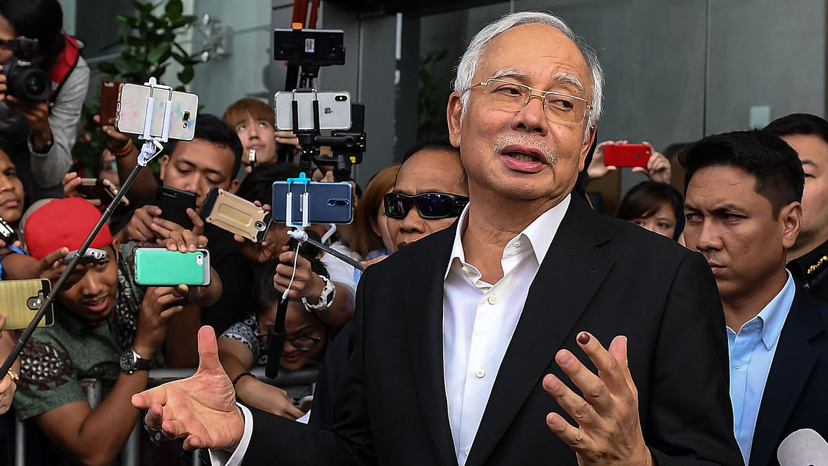 This file photo taken on 24 May shows Malaysia`s former prime minister Najib Razak speaks to the media after being questioned at the Malaysian Anti-Corruption Commission (MACC) office in Putrajaya.
