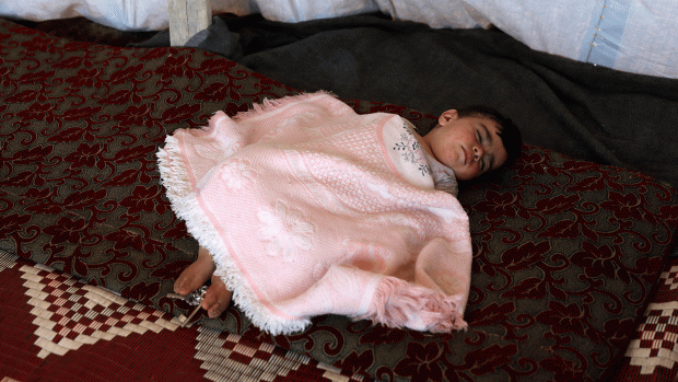 Internally displaced child from Deraa province sleeps inside a tent near the Israeli-occupied Golan Heights, in Quneitra, Syria on 21 June. Photo: Reuters.