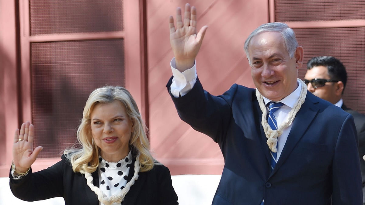 Israeli Prime Minister Benjamin Netanyahu and his wife Sara Netanyahu wave during a visit with Indian Prime Minister Nerendra Modi to the Gandhi Ashram in Ahmedabad on 17 January