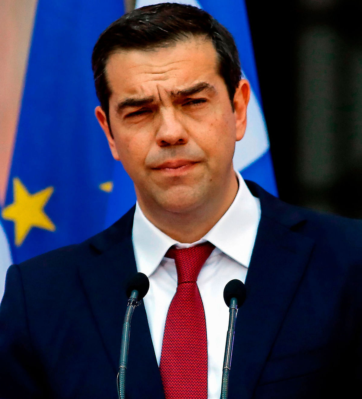 Greek prime minister Alexis Tsipras, wearing a tie, addresses the parliamentary group of leftist Syriza and coalition partner Independent Greeks in Athens, on 22 June after Eurozone financial ministers have agreed to complete the eight-year bailout program for Greece. Photo: AFP