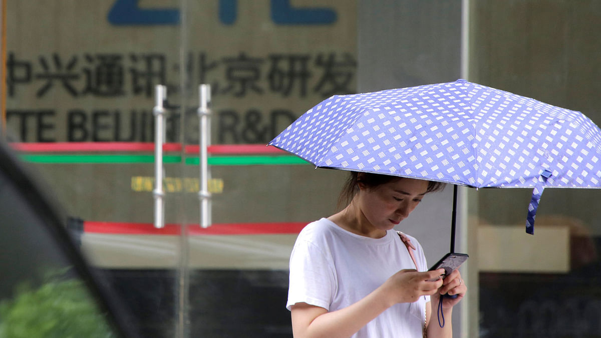 A woman stands outside a building of ZTE Beijing research and development center in Beijing, China on 13 June. Photo: Reuters
