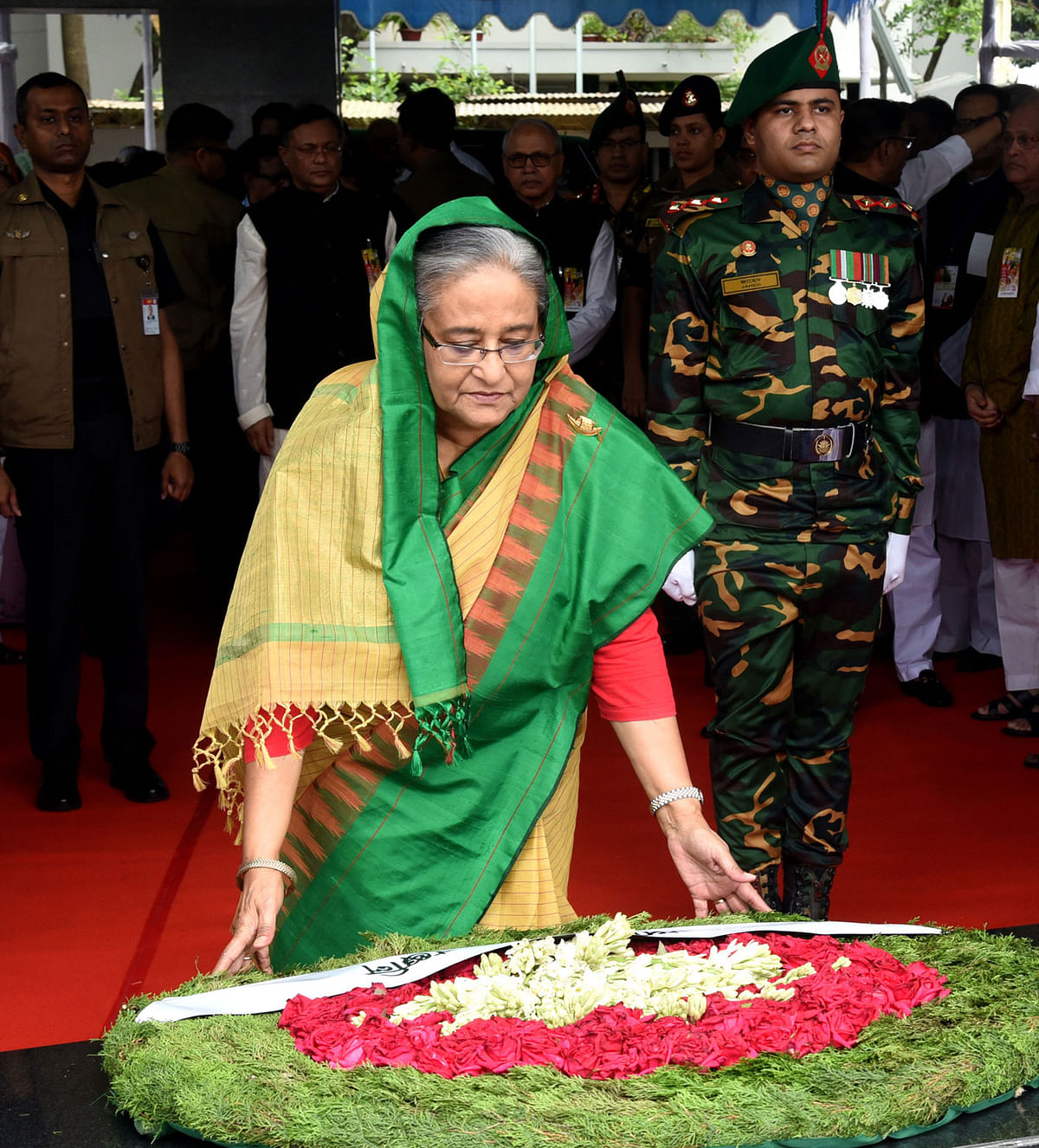 Awami League president and prime minister Sheikh Hasina pays homage to the country’s founding father Sheikh Mujibur Rahman, also her father, at the portrait of Bangabandhu Sheikh Mujibur Rahman on Saturday, marking the 69th founding anniversary of Awami League. Photo: BSS