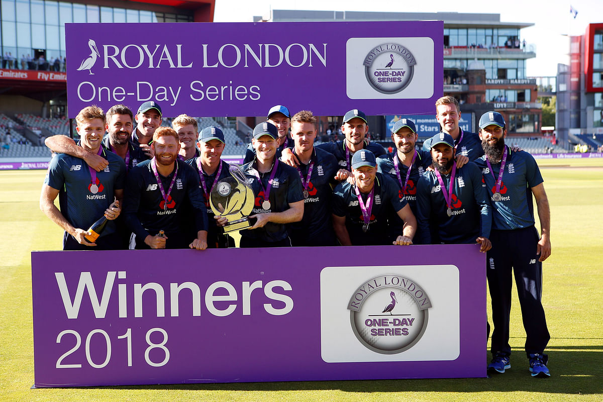 England`s Eoin Morgan celebrates with the trophy and team mates after winning the series. Reuters