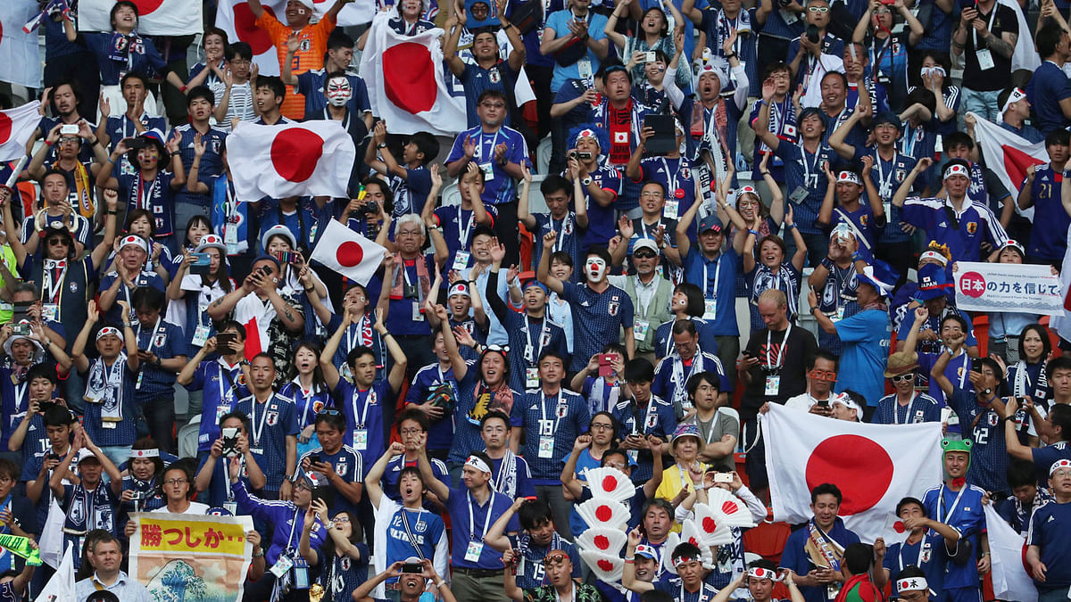 Japan fans celebrate after their match against Colombia on 19 June. Photo: Reuters