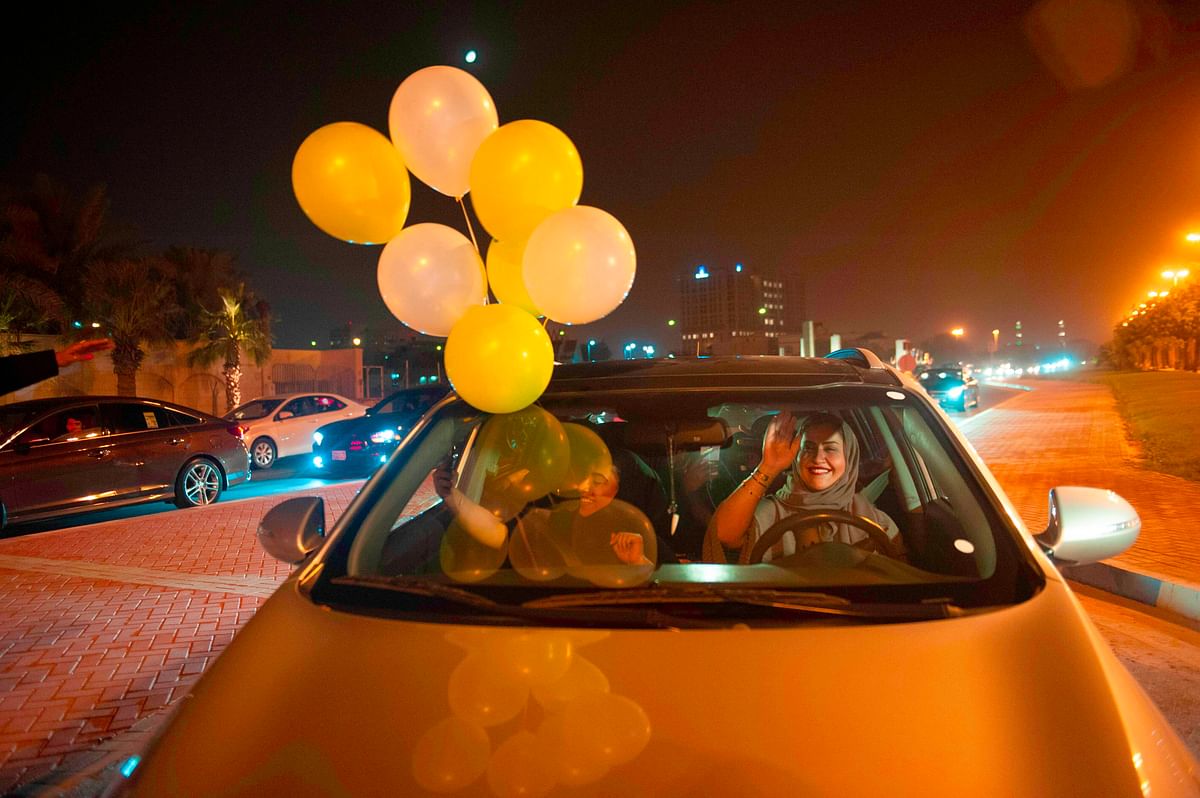 A Saudi woman and her friends celebrate her first time driving on a main street of Khobar City on her way to Kingdom of Bahrain on 24 June 2018. Photo: AFPSaudi women driving ban ends