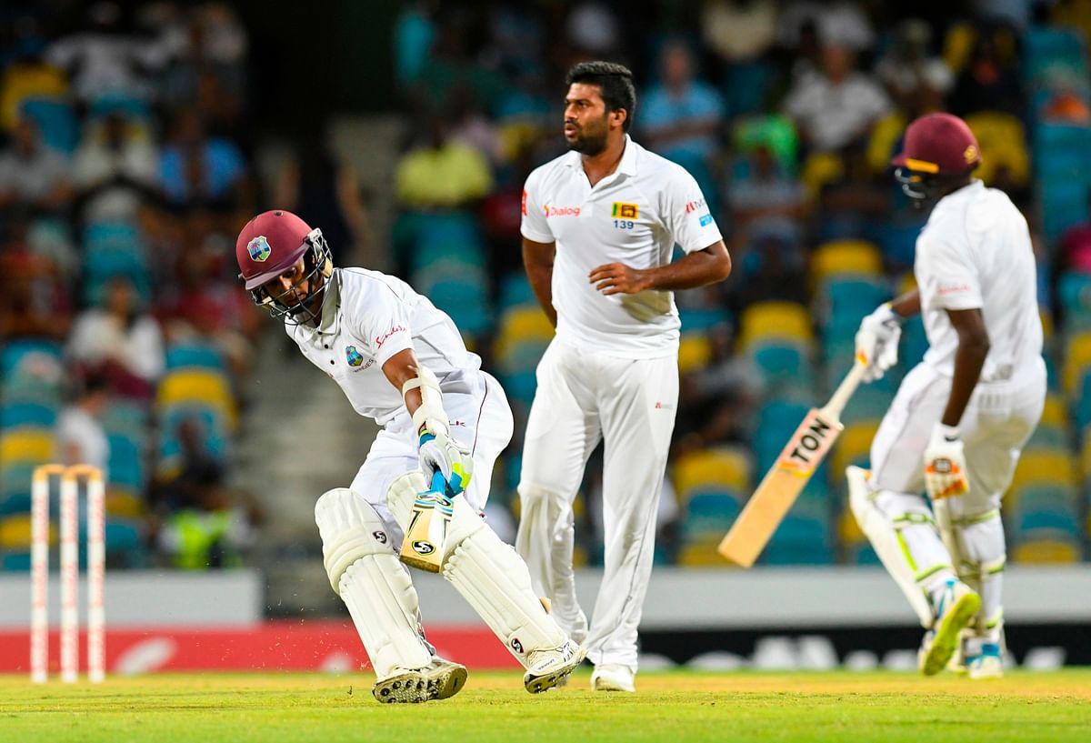 Shane Dowrich and Jason Holder od West Indies take a run as Sri Lanka bowler Kasun Rajitha looks during Day 1 of the 3rd Test between West Indies and Sri Lanka at Kensington Oval, Bridgetown, Barbados, on 23 June 2018. Photo: AFP