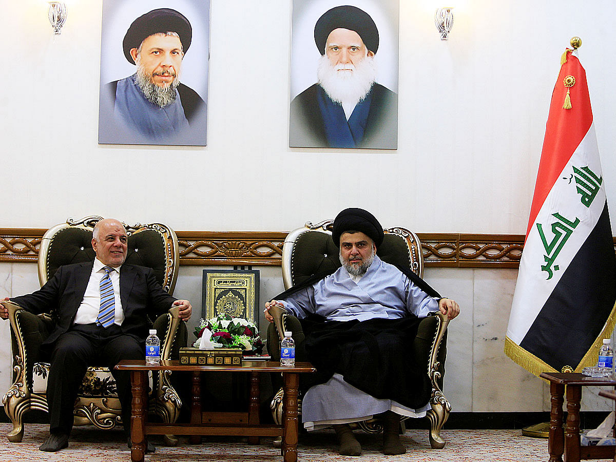Iraqi prime minister Haider al-Abadi, who`s political bloc came third in a May parliamentary election, (L) meets with cleric Moqtada al-Sadr, who`s bloc came first, in Najaf, Iraq on 23 June 2018. Photo: Reuters