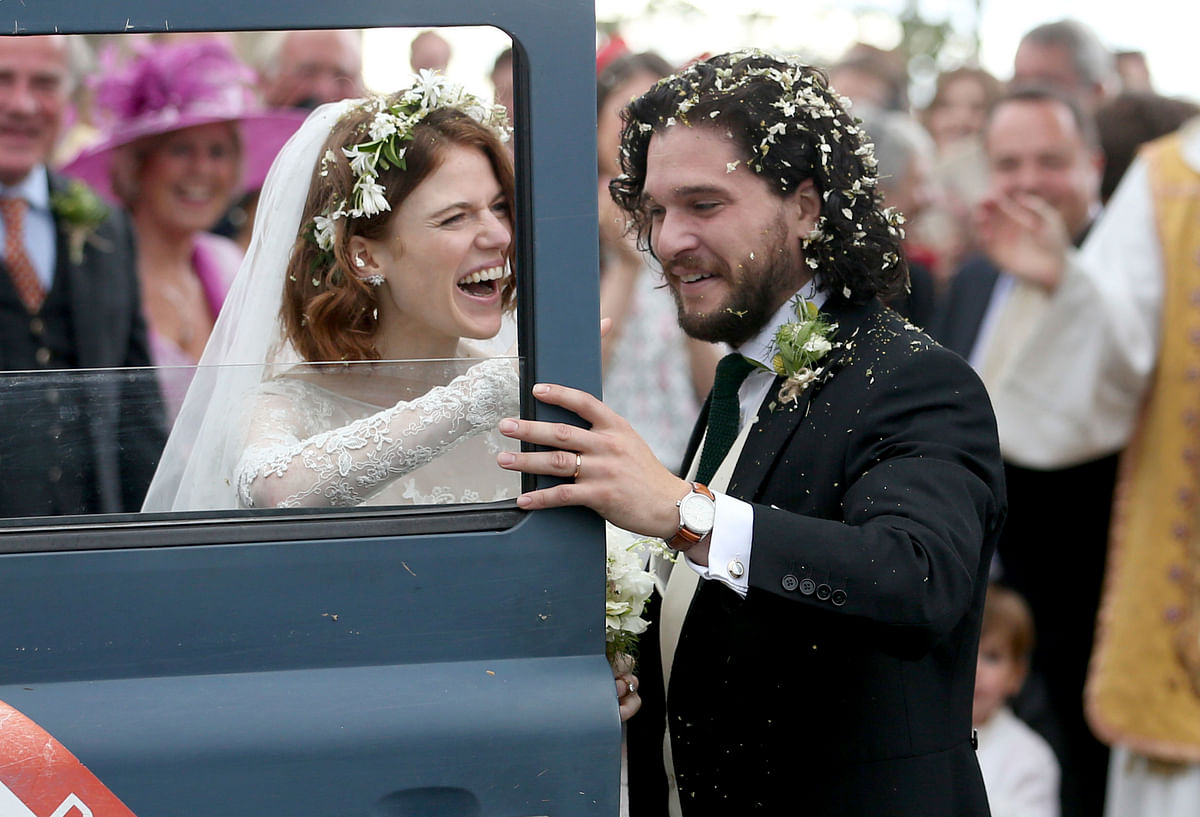 Actors Kit Harington and Rose Leslie reacts as they leave after their wedding ceremony, at Rayne Church, Kirkton of Rayne in Aberdeenshire, Scotland on 23 June