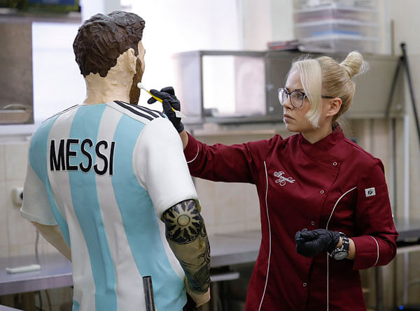 A baker prepares a life-size chocolate sculpture of Argentine soccer player Lionel Messi to top a cake for the celebration of his upcoming birthday in Moscow. Photo: Reuters