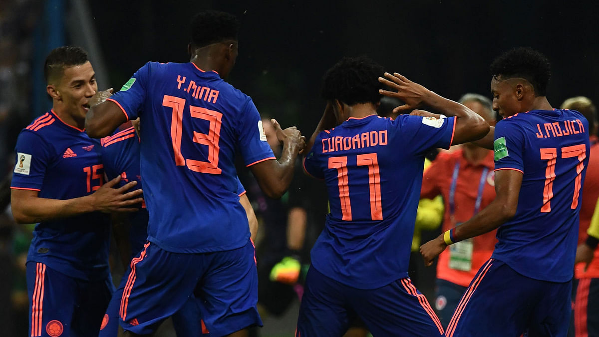 Colombia`s forward Juan Cuadrado (2ndR) celebrates with teammates after scoring during the Russia 2018 World Cup Group H football match between Poland and Colombia at the Kazan Arena in Kazan on 24 June. Photo: AFP