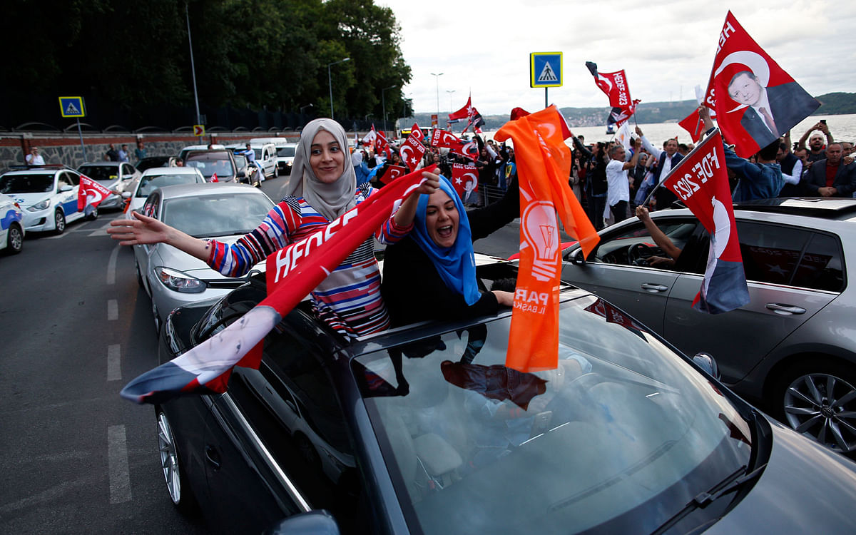Supporters of Turkey president and ruling Justice and Development Party, or AKP, leader Recep Tayyip Erdogan celebrate outside his official residence in Istanbul on 24 June. Photo: AP