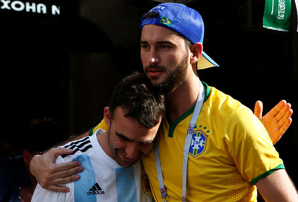 A Brazil fan embraces a supporter of Argentina soccer team as he celebrates Brazil`s victory over Costa Rica at the World Cup Group E soccer match in central Moscow. Photo: Reuters