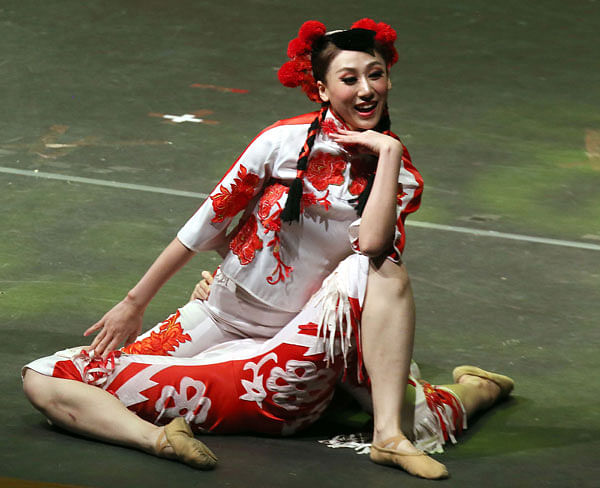 A Dancer from China’s Guangxi cultural and Art Troupe perform during international music festival, at the Abdulhusain Abdulredha theatre in Kuwait City on 24 June. Photo: AFP