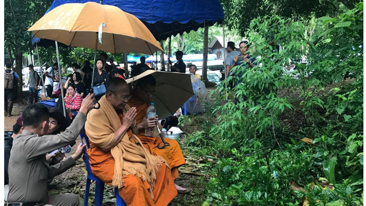 Buddhist monks pray outside the Tham Luang caves, where 13 members of an-under 16 soccer team are trapped, in the northern province of Chiang Rai, Thailand, on 25 June 2018. -- Reuters