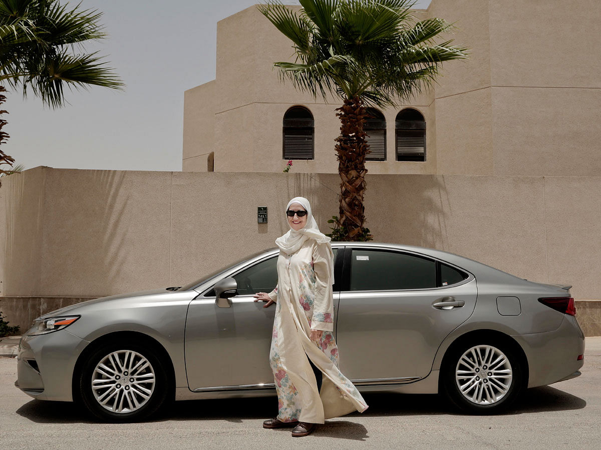 In this Sunday, 24 June 2018 photo, Ammal Farahat, who has signed up to be a driver for Careem, a regional ride-hailing service that is a competitor to Uber, poses for a photograph next to her car on a street in Riyadh, Saudi Arabia. It`s the latest job opening for Saudi women that had been reserved for men only and one that sharply challenges traditional norms. Photo: AP