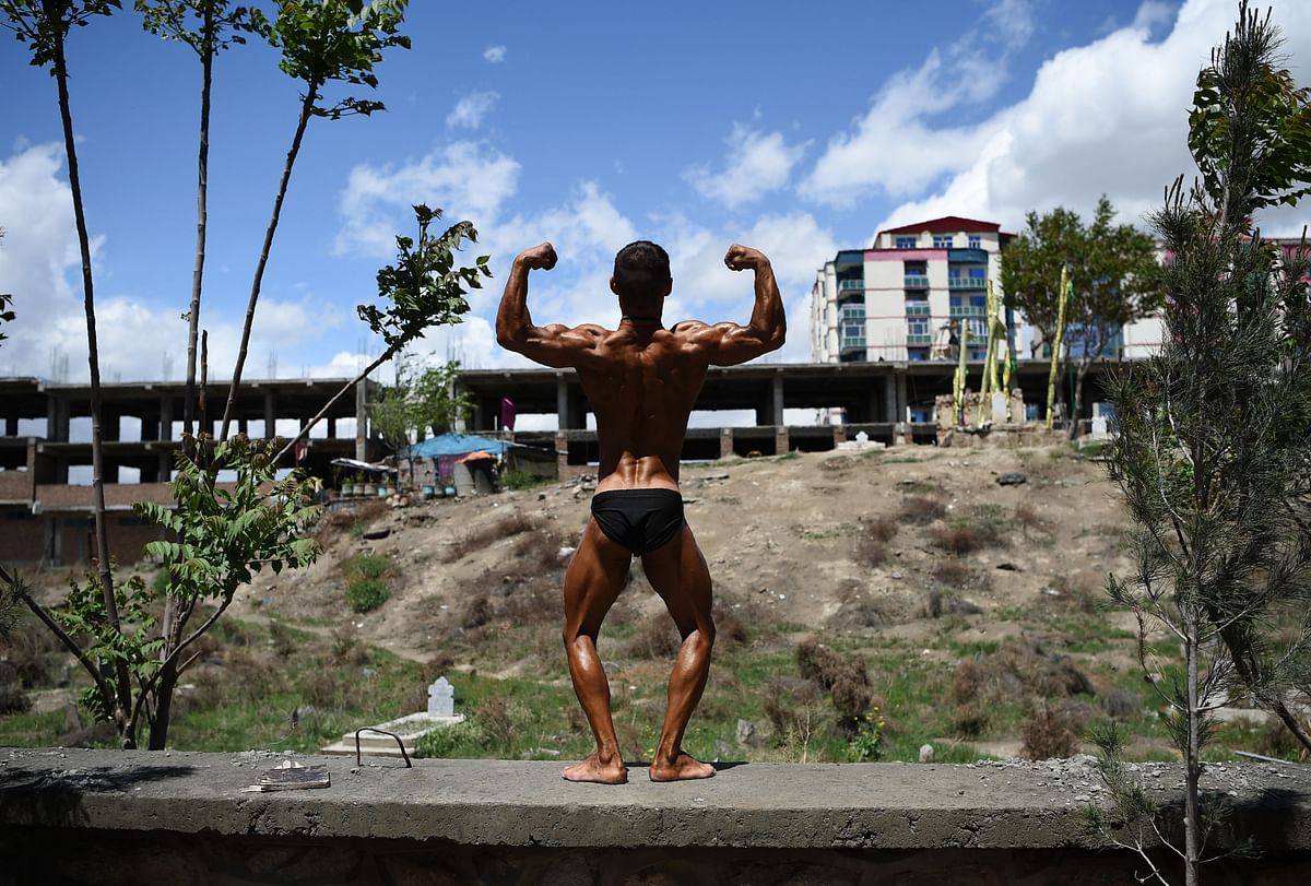 This photo taken on 18 April 2018 shows an Afghan bodybuilder posing after competing in a bodybuilding and fitness contest in Kabul. Photo: AFP