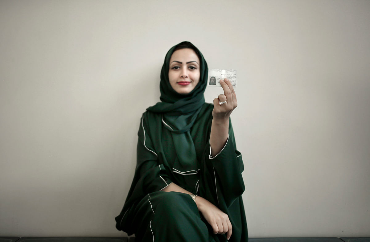 In this 23 June 2018 file photo, 34-year old Asmaa al-Assdmi poses for a photograph holding her new car license at the Saudi Driving School inside Princess Nora University in Riyadh, Saudi Arabia. Saudi women are on the roads and steering their way through busy city streets freely for the first time after years of risking arrest if they dared to get behind the wheel. Photo: AP
