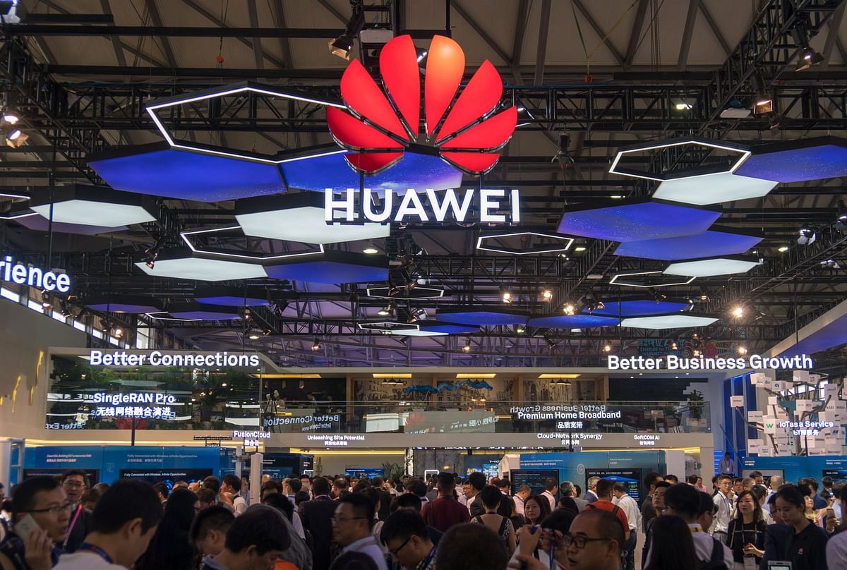 People gather at the Huawei stand during the Mobile World Conference in Shanghai on 27 June. Photo: AFP