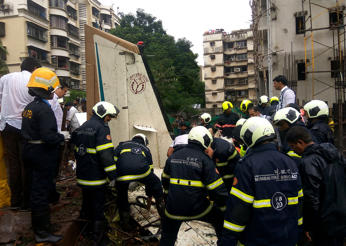 Firefighters inspect the sight of a plane crash in Mumbai on 28 June. Photo: Reuters