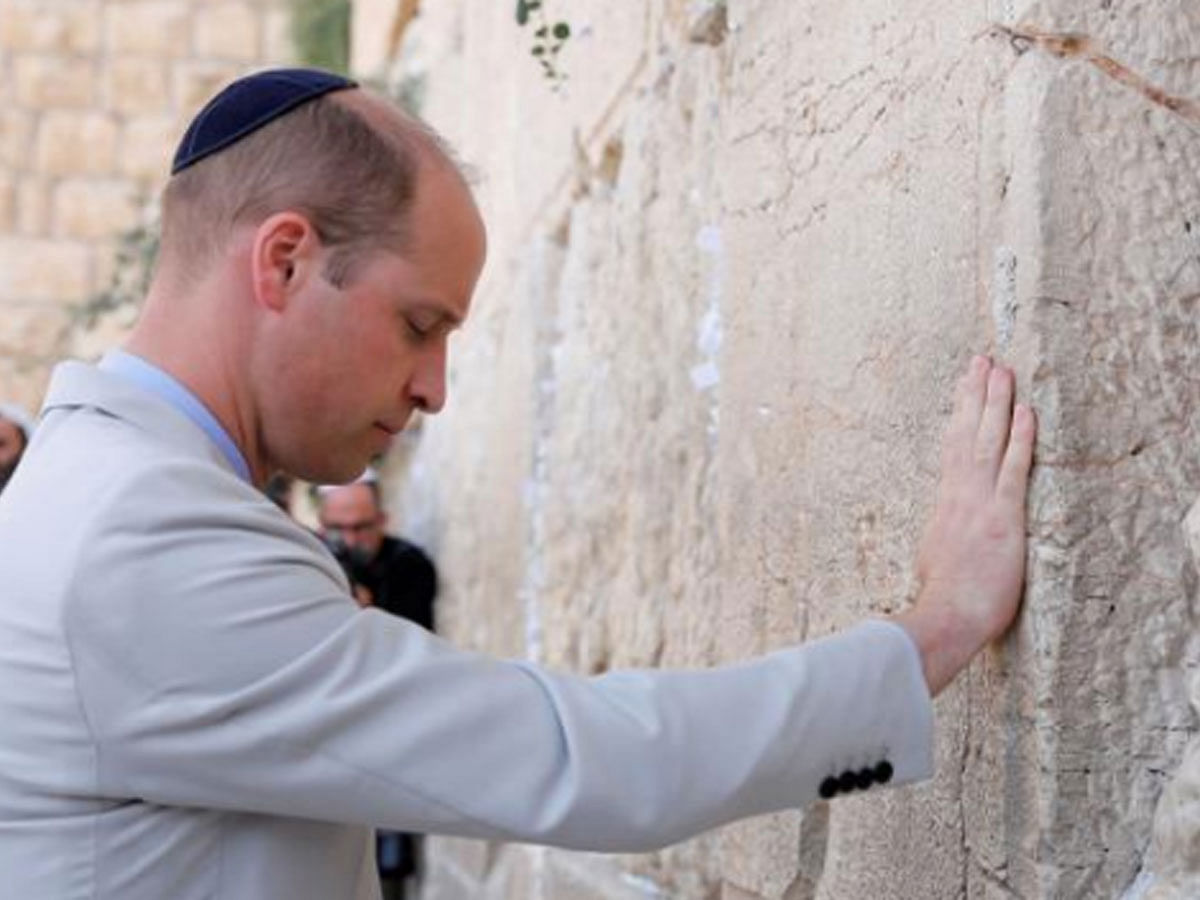 Britain`s Prince William touches the Western Wall, Judaism`s holiest prayer site, in Jerusalem`s Old City, on 28 June 2018. -- Reuters