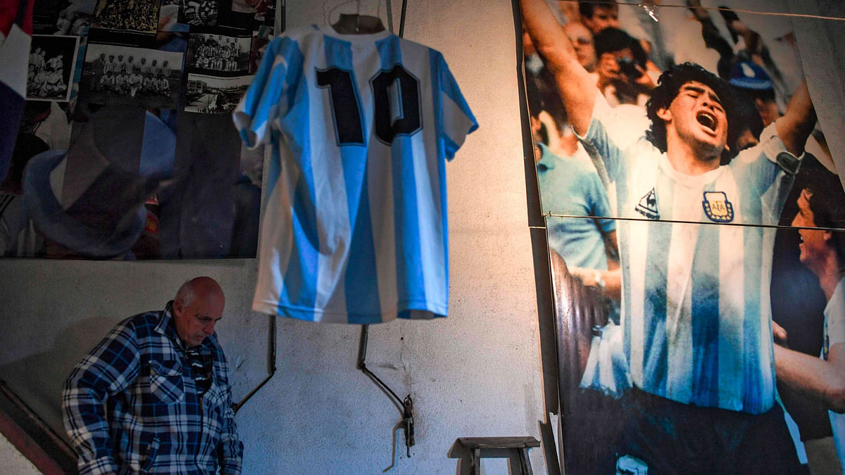 The former director of Argentinos Juniors sports club and owner of the `Casa de Dios` (House of God) museum, Alberto Perez, walks down the stairs past Argentine football star Diego Maradona`s memorabilia in Buenos Aires, on 27 June 2018. Photo: AFP
